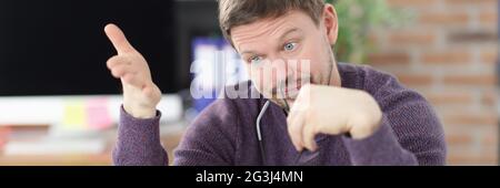 Surprised man looks at laptop screen in office Stock Photo