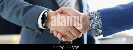 Two businessmen are shaking hands friendly closeup Stock Photo
