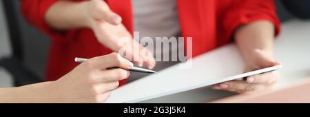 Partners discuss working moments on tablet closeup Stock Photo