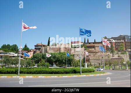 Georgian and EU flags in main square in Tbilisi on blue sky background Stock Photo