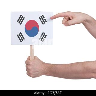 Hand holding small card - Flag of South Korea Stock Photo