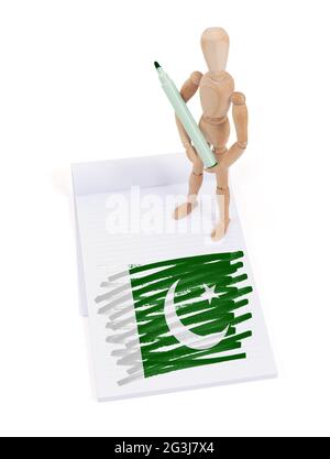 Wooden mannequin made a drawing - Pakistan Stock Photo