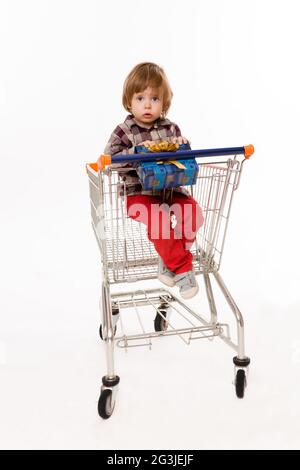 Little baby sitting in shopping cart Stock Photo