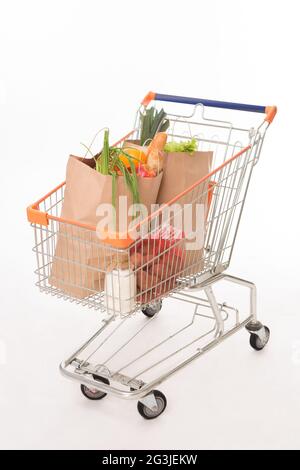 Shopping cart with shopping bags Shopping cart with shopping bags Stock Photo