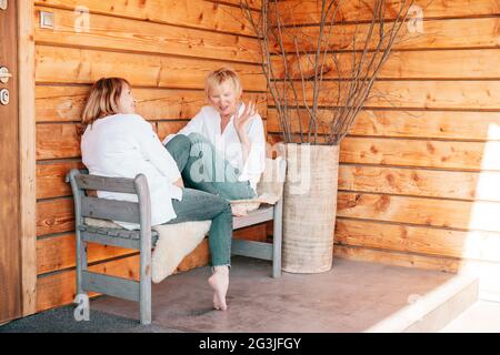 Two girlfriends 55 years old are talking and having fun together, photo Stock Photo