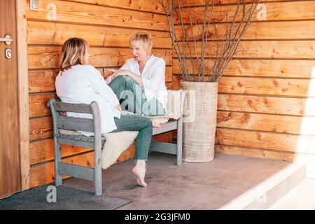 Two girlfriends 55 years old are talking and having fun together Stock Photo