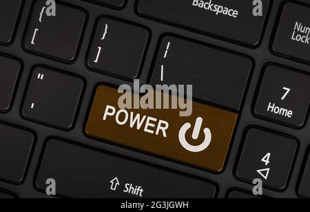 Brown power button on a black laptop keyboard Stock Photo