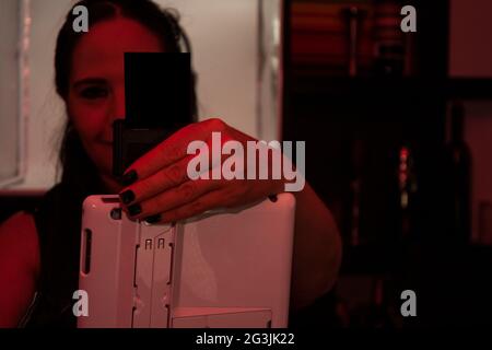 Female hand operating payment procces  card reader and  technology on a bar counter in Mexico City Stock Photo