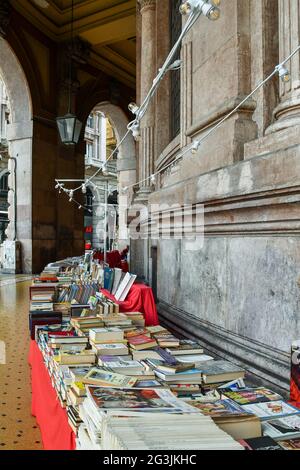 Second-hand book market under the arcade of Via XX Settembre in the city center of Genoa, Liguria, Italy Stock Photo