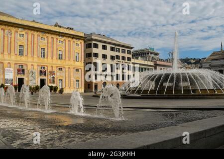 View of Piazza De Ferrari, Genoa's main square, with the bubbling fountains and Palazzo Ducale ancient palace in the background, Liguria, Italy Stock Photo