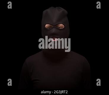 Masked thief on black Stock Photo