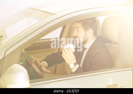 Businessman eating on to go Stock Photo