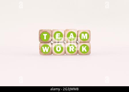 Illustration of eight dices in two rows with text TEAM WORK on white background Stock Photo