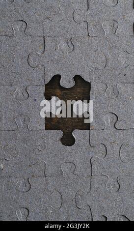Paper Puzzle with one Piece Missing from the Center Stock Photo