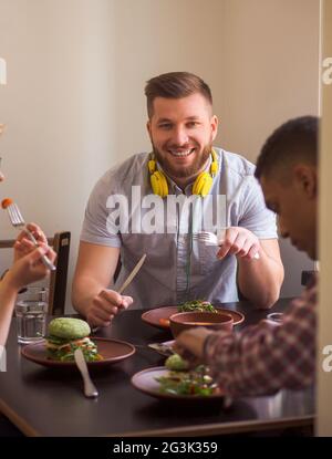 Happy friends in vegan restaurant Stock Photo