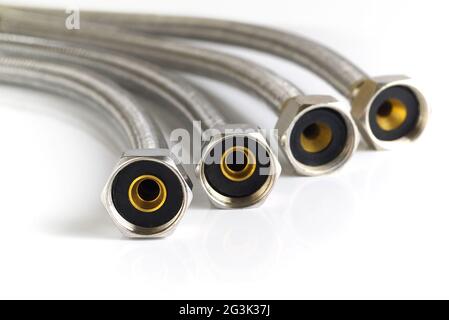 four braided steel flexes on white background, shallow depth of field, closeup Stock Photo