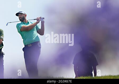 Dustin Johnson, of the United States, watches his tee shot on the 11th ...