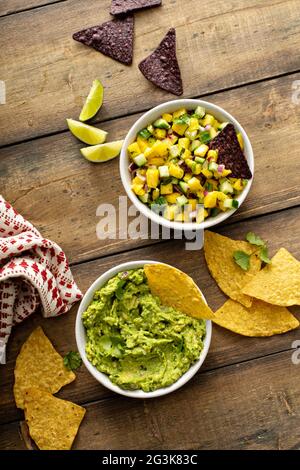 Tortilla chips with dips, guacamole and salsa Stock Photo