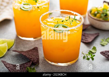 Pineapple and mango margarita with chips and guacamole Stock Photo