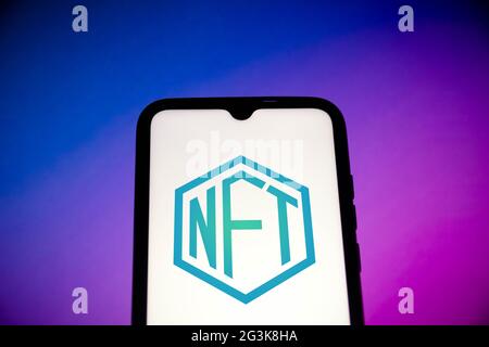 In this photo illustration, a NFT (Non-fungible token) logo seen displayed on a smartphone. Stock Photo