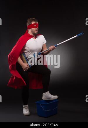 Super hero with cleaning equipment Stock Photo