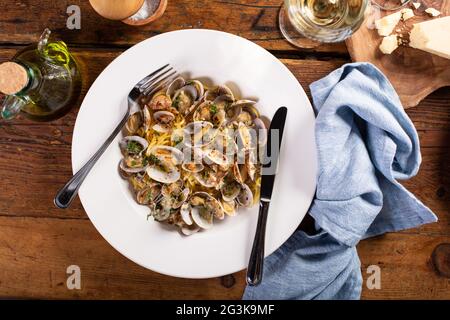 Seafood linguine pasta with clams served with wine Stock Photo