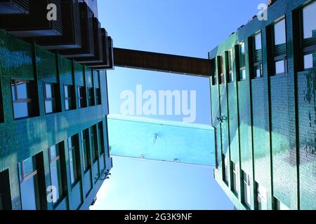 London, UK. Looking up at the newly-opened Sky Pool at Embassy Gardens in Nine Elms where swimmers can take in views from 115ft in the air. Stock Photo