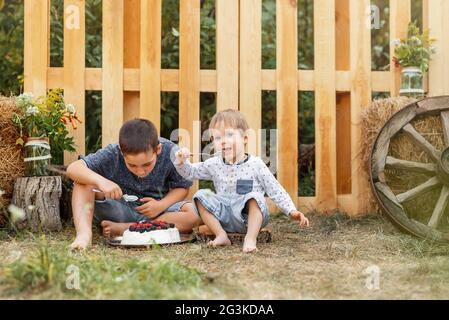 Two cute boys happily eating healthy food outdoors. Adventure time. Stock Photo
