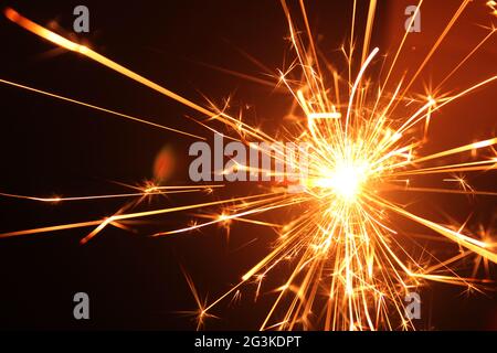 A burning sparkler on black Stock Photo