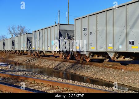 Elgin, Illinois, USA. A Canadian National Railway freight train made up of empty hopper cars passing through northeastern Illinois. Stock Photo