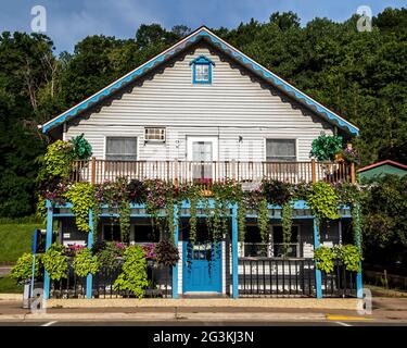 Lots of flowers on the balcony and in pots at Tangled Up in Blue Restaurant on Bench St., Taylors Falls, Minnesota USA. Stock Photo