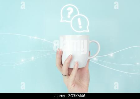FAQ frequently asked questions concept. Girl hand hold morning coffee cup with FAQ question answer sign Icon on blue background. Business support conc Stock Photo