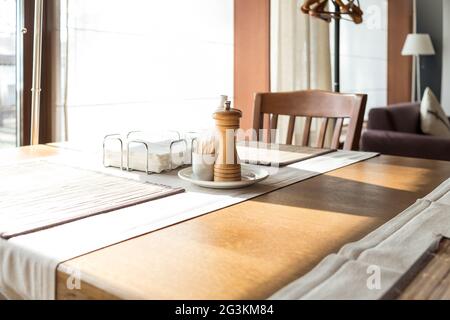Part of restaurant table setting salt, pepper, toothpicks and paper napkins in wooden box on table Stock Photo