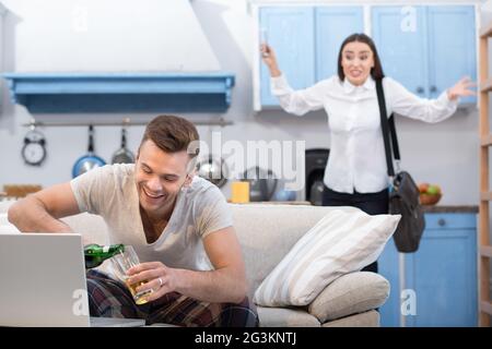 Woman going to work fights her unreliable husband. Stock Photo