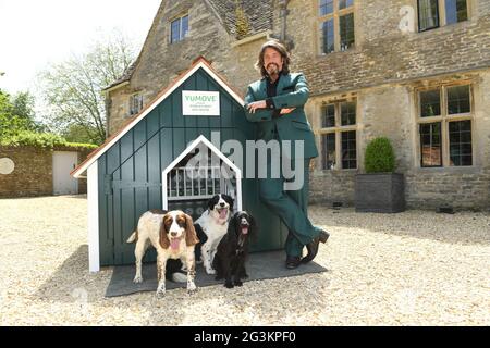 EDITORIAL USE ONLY Television personality and interior designer, Laurence Llewelyn-Bowen, alongside his pets, unveils the 'World's Best Dog House', which he has designed in partnership with canine joint supplement brand YuMOVE for a new campaign to encourage dog owners to make simple home improvements that can benefit the long-term health and wellbeing of their pets, Cirencester. Issue date: Thursday June 17, 2021. Stock Photo