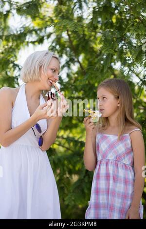 Happy moments, mother and daughter in park eating ice cream. Stock Photo