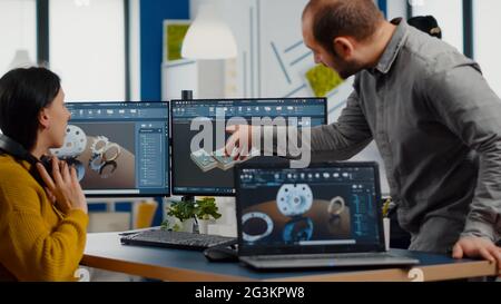 Industrial development engineer analysing and sharing ideas with project manager working on computer. Team of professionals using CAD Software for modern industrial engineering design. Stock Photo