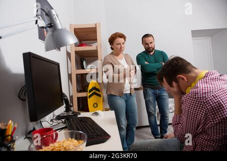 Parents scolding their teenage son in his room. Stock Photo