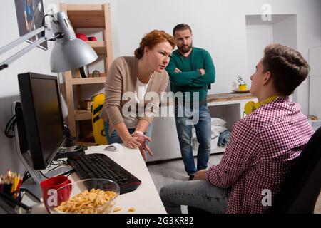 Parents arguing with teenage son. Stock Photo