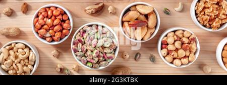 Nuts panorama with pistachios, peanuts, cashews and many other nuts, top shot Stock Photo