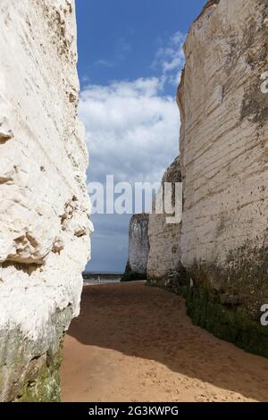 Looking through a passage in between white chalk stacks, Botany bay beach, Broadstairs, Kent, England Stock Photo