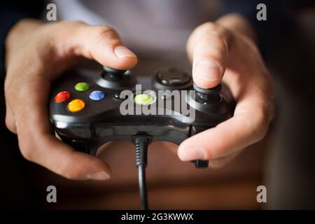 Close up view of joystick in mans hands. Stock Photo