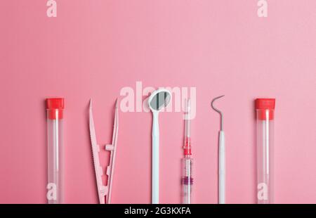 Medical instruments, devices and items on the colored table in the hospital. Syringe, test tube, tweezers. Healthcare, medicine, treatment and doctors concept. High quality photo Stock Photo