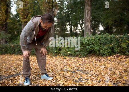 Tired man after long running. Stock Photo