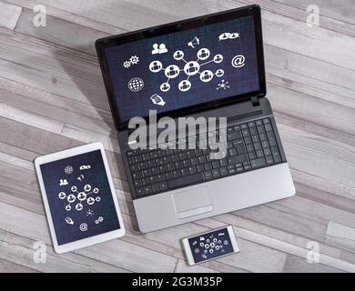 Social network concept shown on different information technology devices Stock Photo