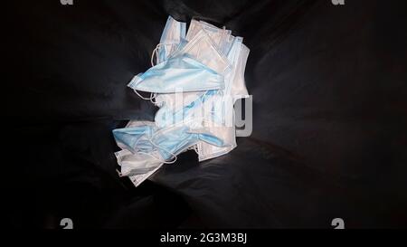 Single-use surgical face mask container. Environmental pollution in nature concept Stock Photo