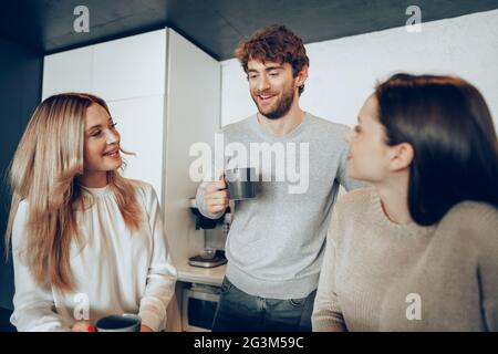 Young businesspeople colleagues having a coffee break in office, drinking and talking Stock Photo