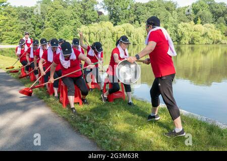 Middle age Chinese American dancer performing artists rehearse a rowing routine at a park in Flushing, Queens, New York City Stock Photo