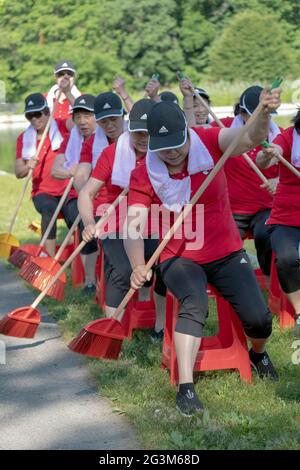 Middle age Chinese American dancer performing artists rehearse a rowing routine at a park in Flushing, Queens, New York City Stock Photo