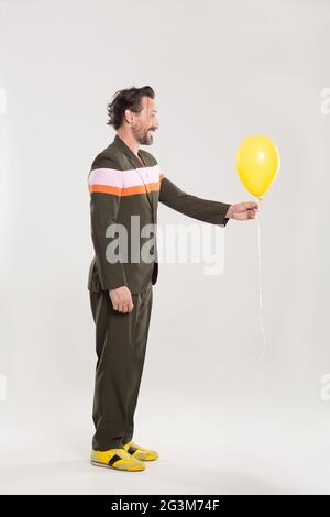 Happy man with yellow balloon Stock Photo